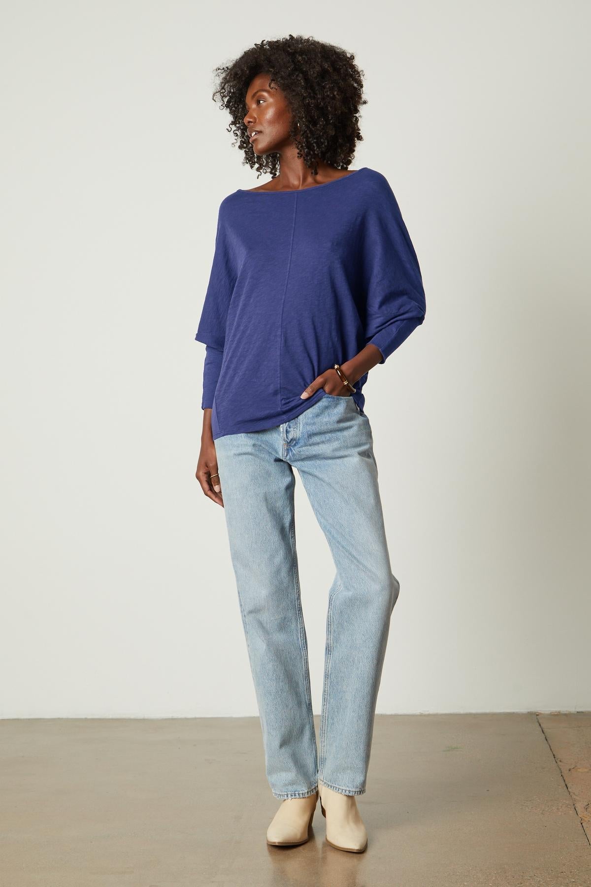 The model is wearing Velvet by Graham & Spencer jeans and a blue sweater.-35206719307969