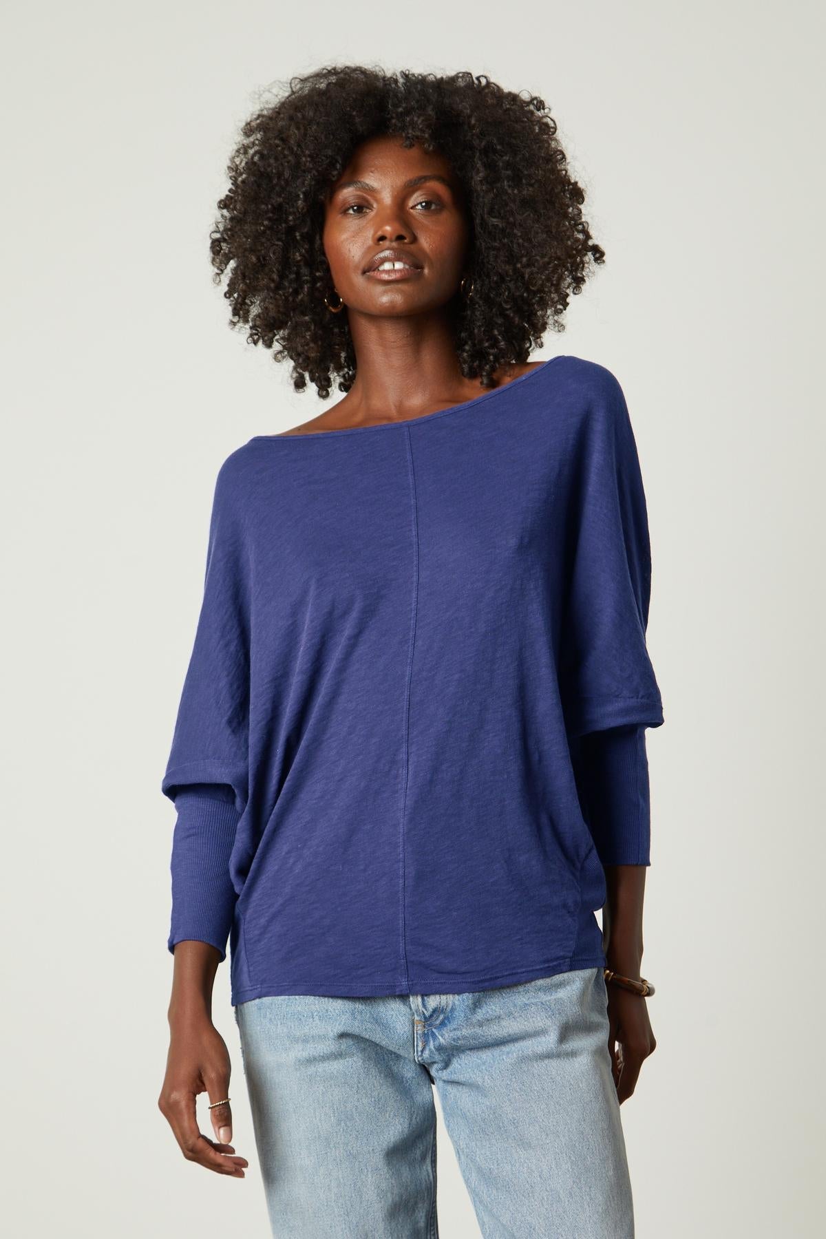 A woman wearing jeans and a Velvet by Graham & Spencer JOSS DOLMAN SLEEVE TEE.-35206718947521