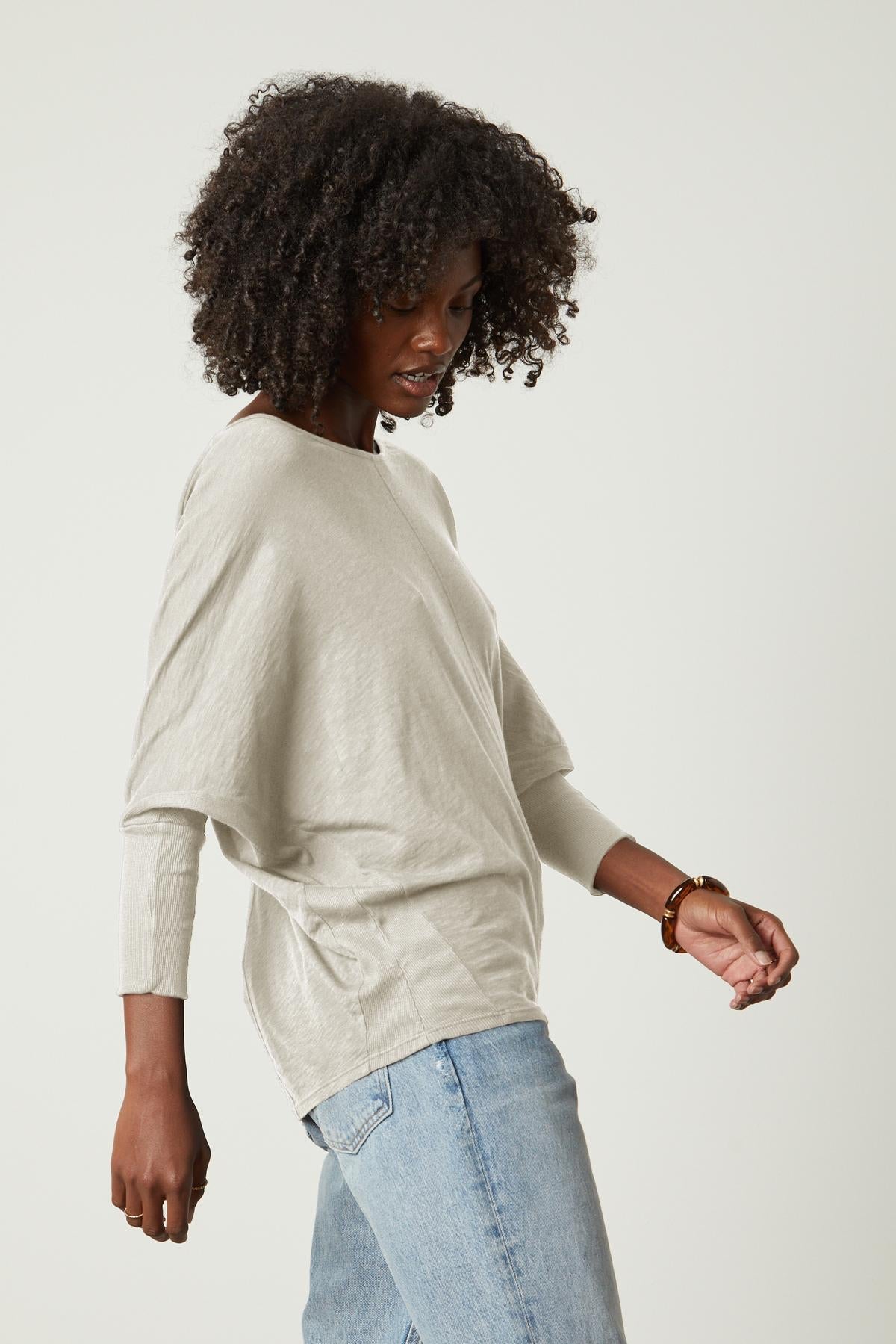   A woman wearing jeans and a Velvet by Graham & Spencer JOSS DOLMAN SLEEVE TEE side view 