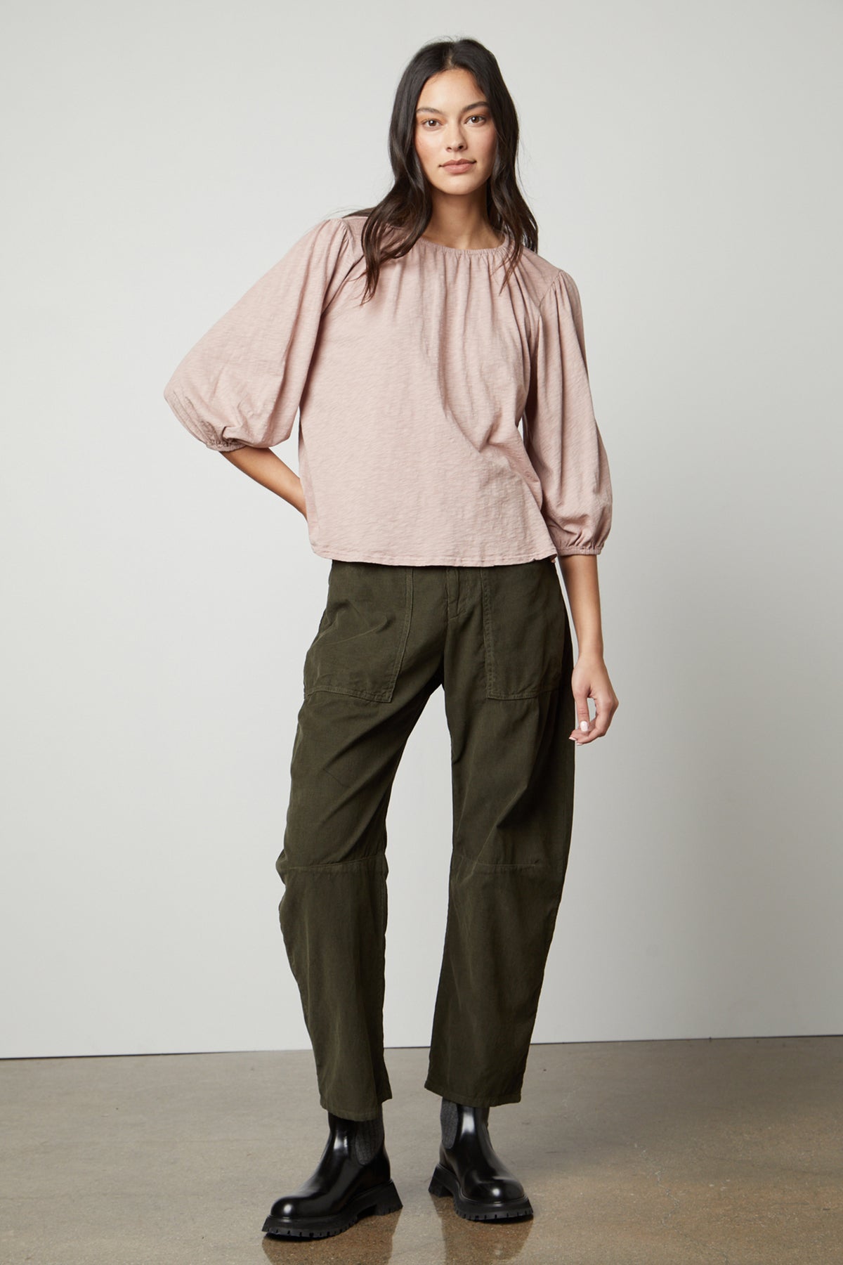The model is wearing olive trousers and a Velvet by Graham & Spencer JULIE 3/4 SLEEVE TEE.-26727740342465