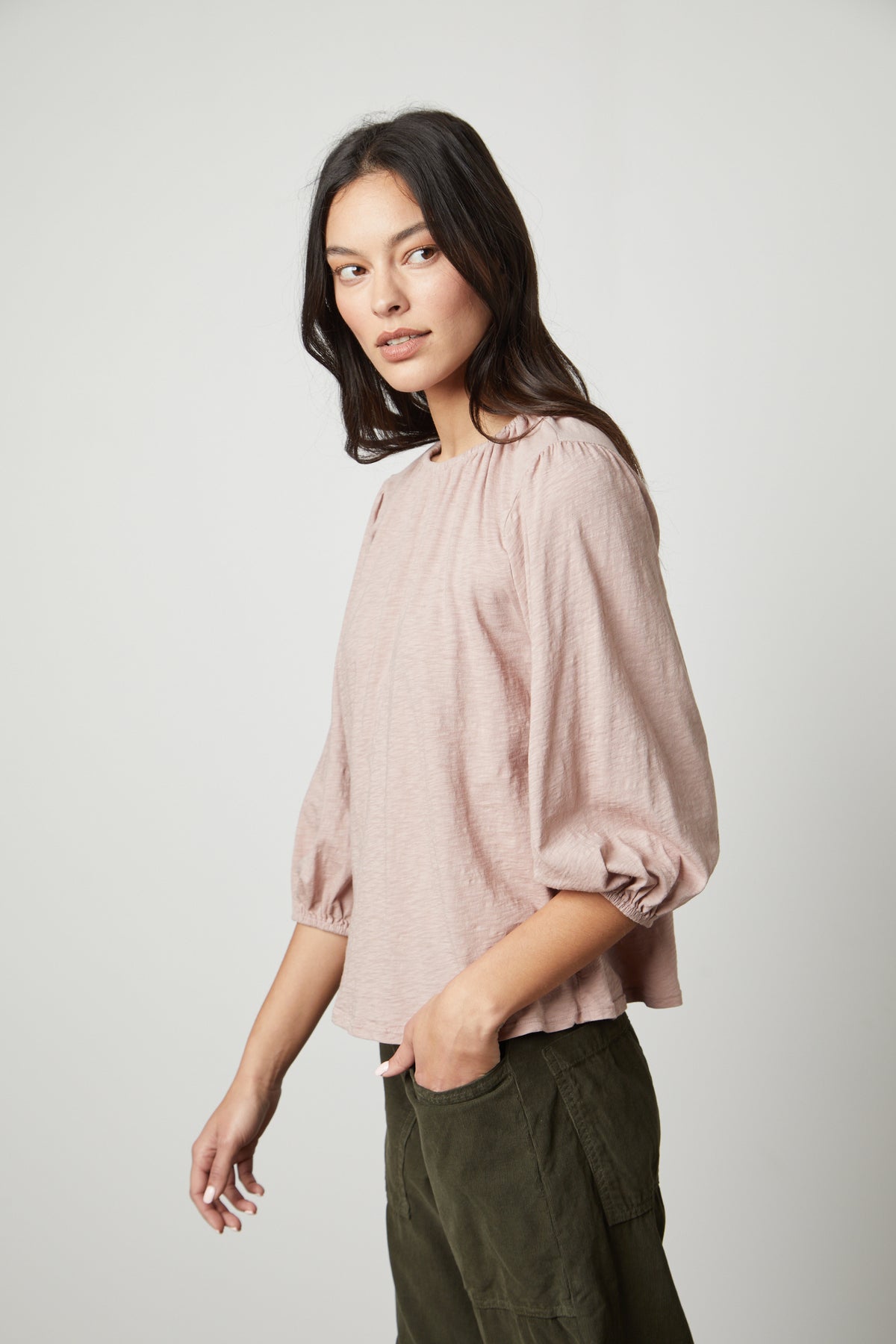   The model is wearing a Velvet by Graham & Spencer JULIE 3/4 SLEEVE TEE with a ruffled sleeve. 