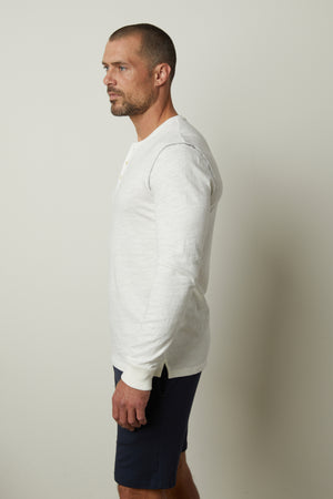 A man wearing a Velvet by Graham & Spencer GABE HENLEY shirt with a vintage feel.