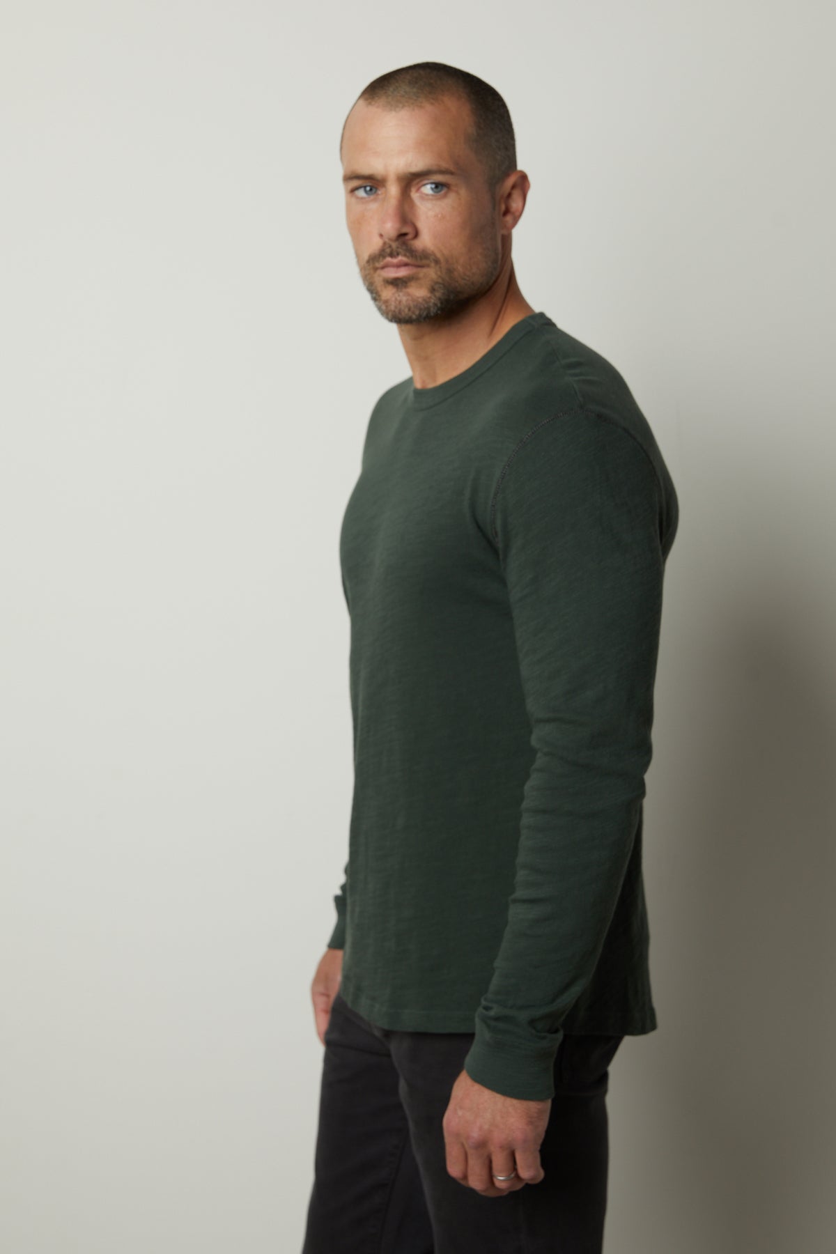   A man wearing a Velvet by Graham & Spencer PALMER CREW NECK TEE in a green long-sleeved shirt. 