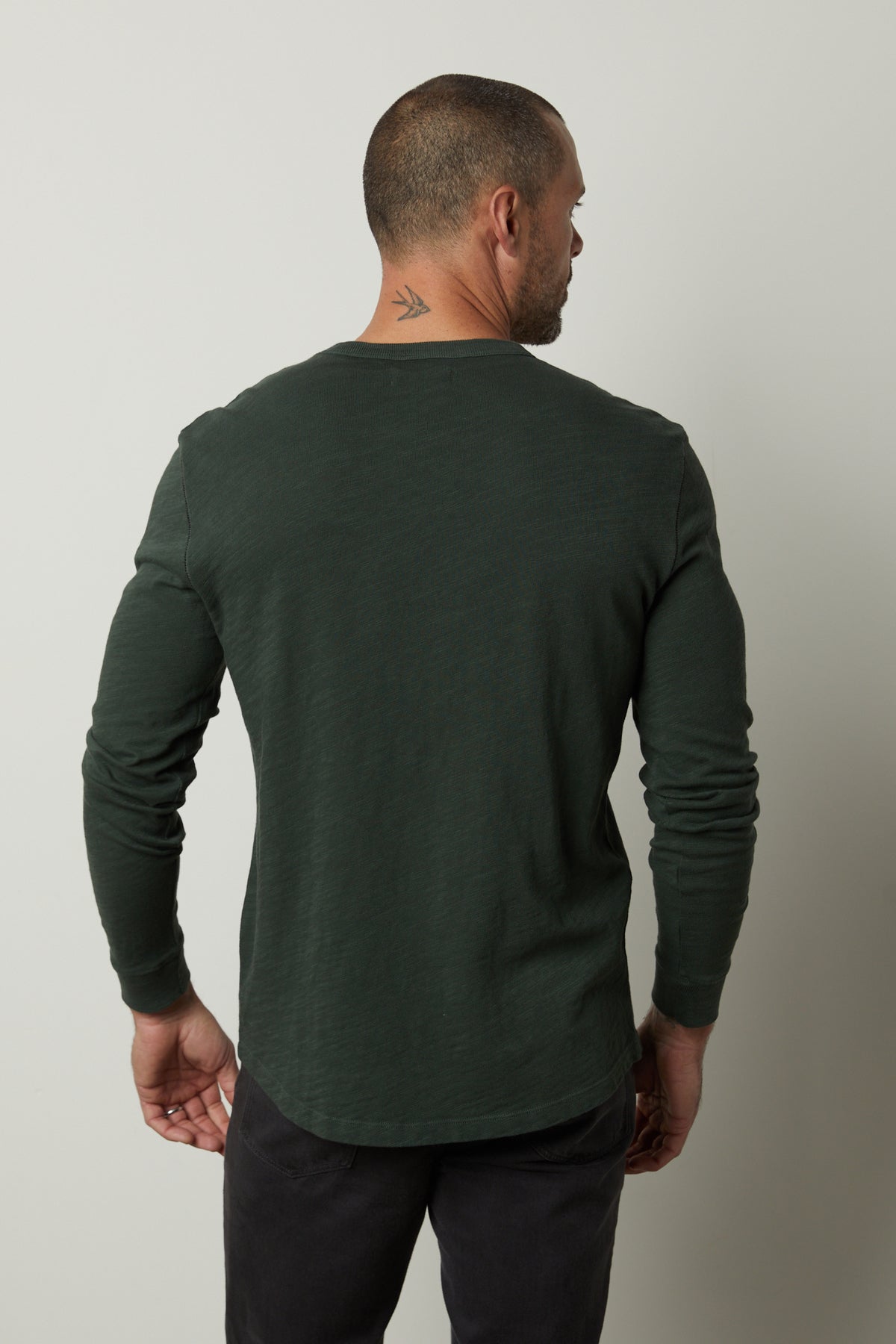   The back view of a man wearing a PALMER CREW NECK TEE made by Velvet by Graham & Spencer, made of soft cotton slub knit, with ribbed neckline and cuffs. 
