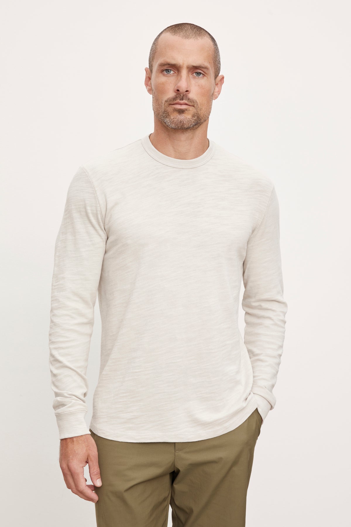 The man is wearing a Velvet by Graham & Spencer PALMER CREW NECK TEE.-36008977498305
