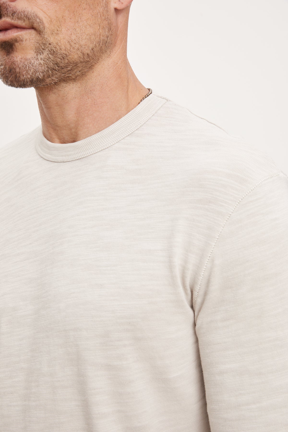 A man wearing a Velvet by Graham & Spencer Palmer Crew Neck Tee made of soft cotton slub knit.-36008977596609