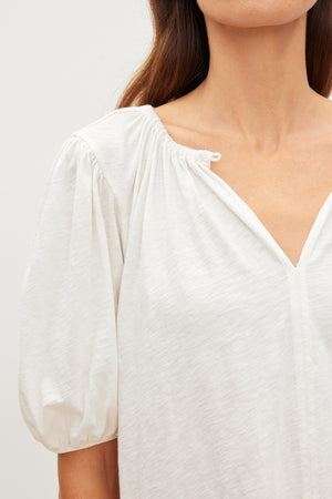 A woman wearing a Velvet by Graham & Spencer relaxed fit tee in cotton slub with puff sleeves.