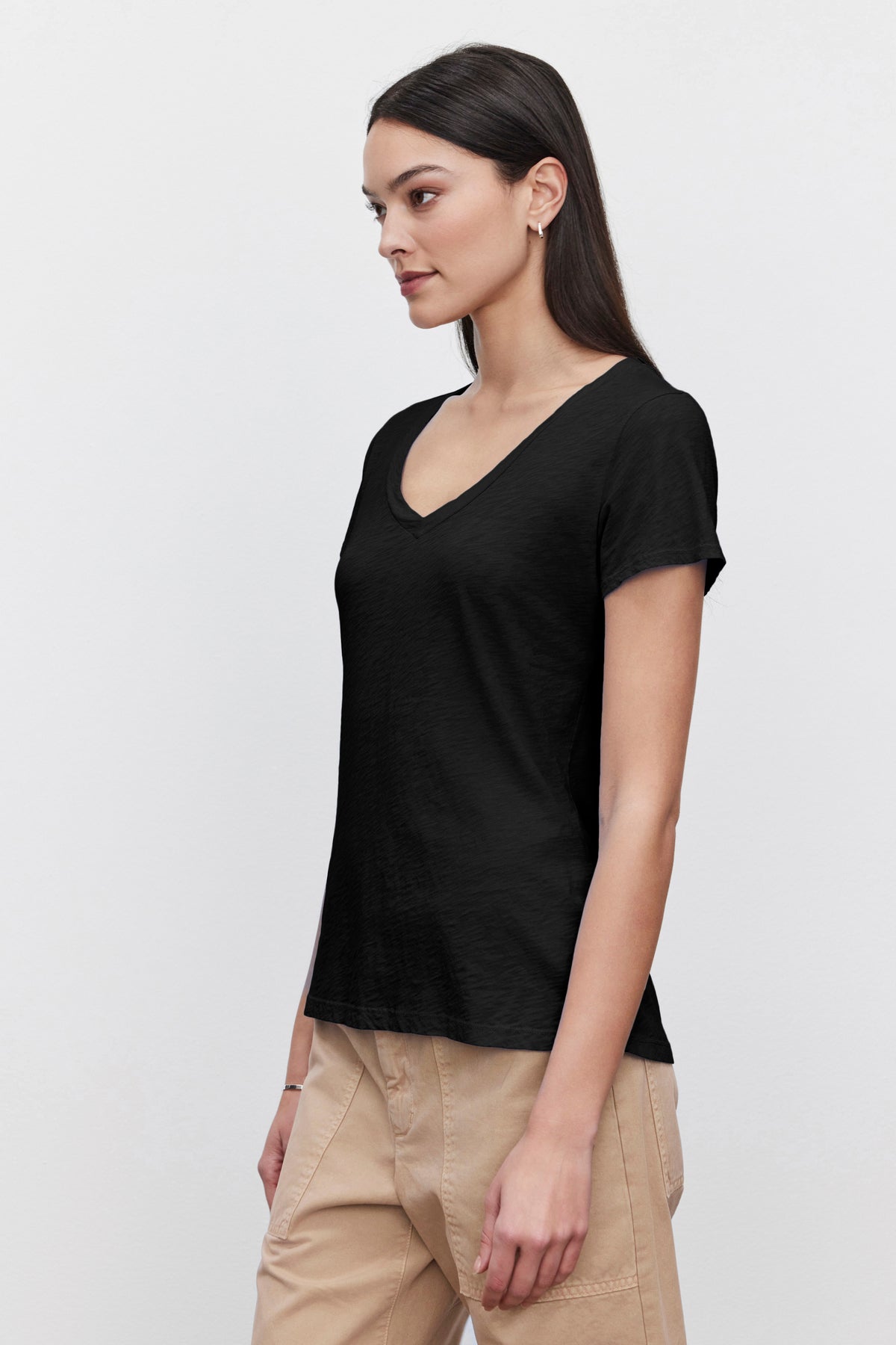 A woman in a black Velvet by Graham & Spencer LILITH COTTON SLUB V-NECK TEE.-36273850581185