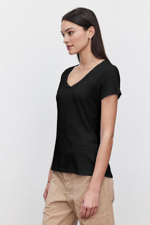 A woman in a black Velvet by Graham & Spencer LILITH COTTON SLUB V-NECK TEE.