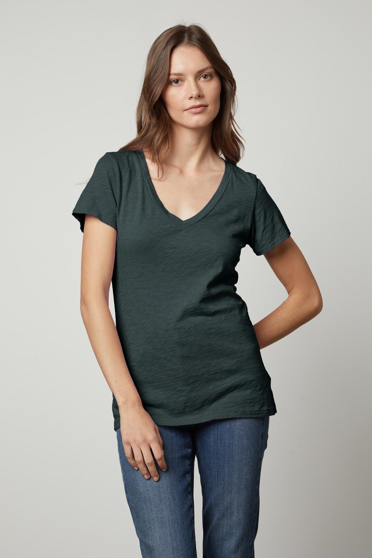 A woman sporting a great LILITH COTTON SLUB V-NECK TEE in a dark green color from Velvet by Graham & Spencer.-35782981615809