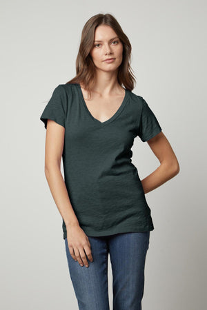 A woman sporting a great LILITH COTTON SLUB V-NECK TEE in a dark green color from Velvet by Graham & Spencer.