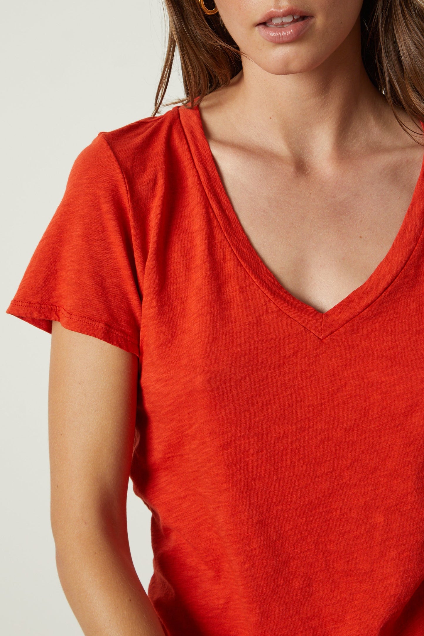 a woman wearing an orange Velvet by Graham & Spencer LILITH COTTON SLUB V-NECK TEE.-26630611337409