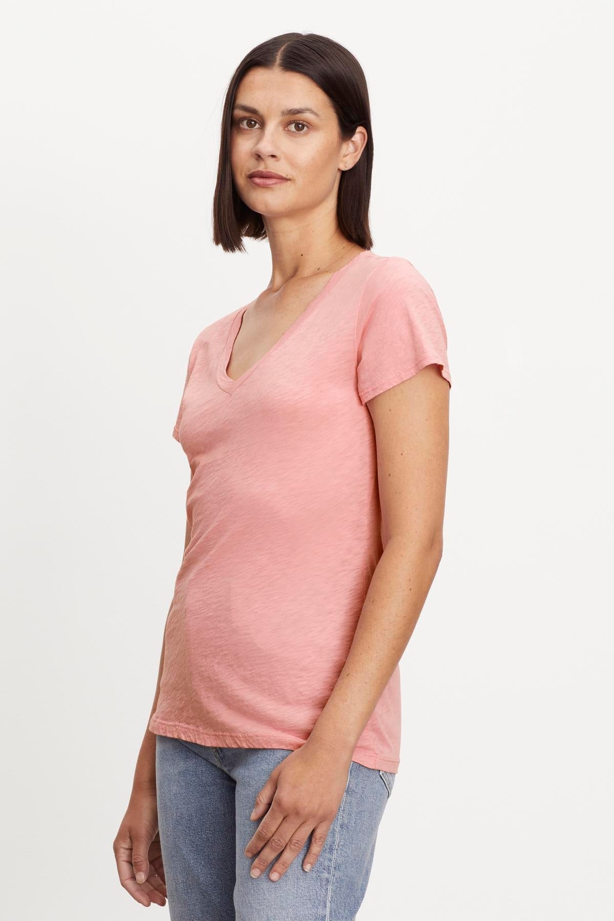   A woman in a Velvet by Graham & Spencer Lilith Cotton Slub V-Neck Tee. 