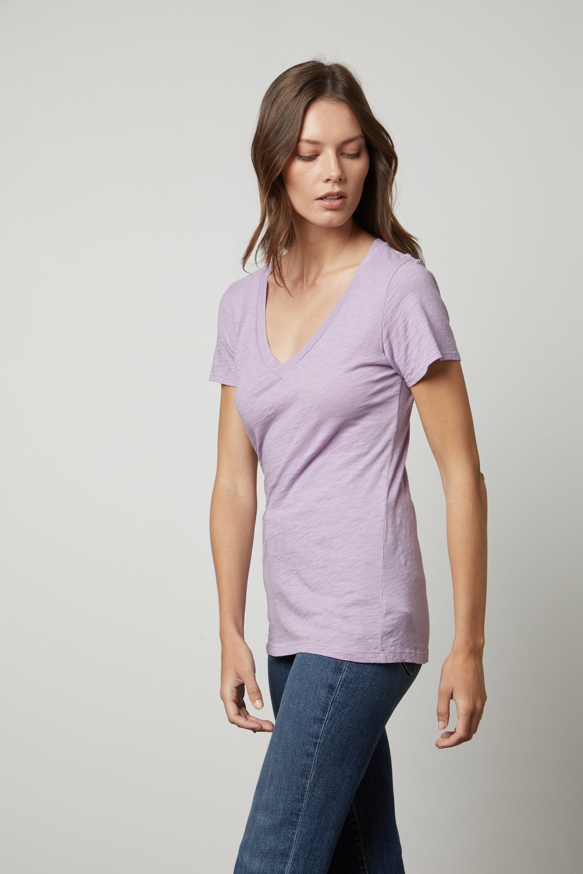   A woman with a tomboy style wearing a Velvet by Graham & Spencer LILITH COTTON SLUB V-NECK TEE. 