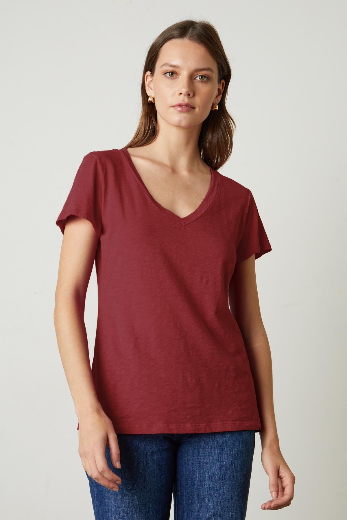 A preppy woman donning a Velvet by Graham & Spencer LILITH COTTON SLUB V-NECK TEE.-35782982238401