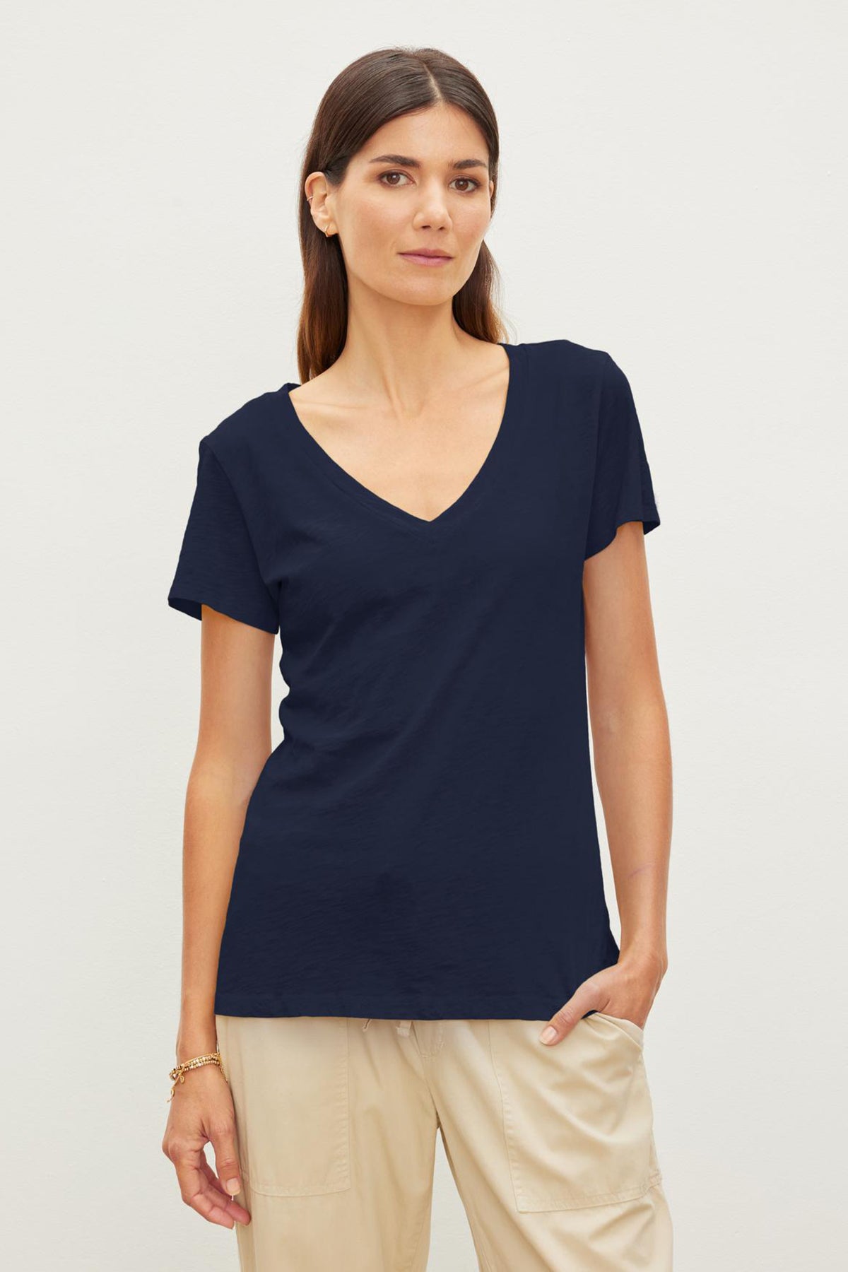 A woman wearing a Navy LILITH COTTON SLUB V-NECK TEE by Velvet by Graham & Spencer.-36273850450113