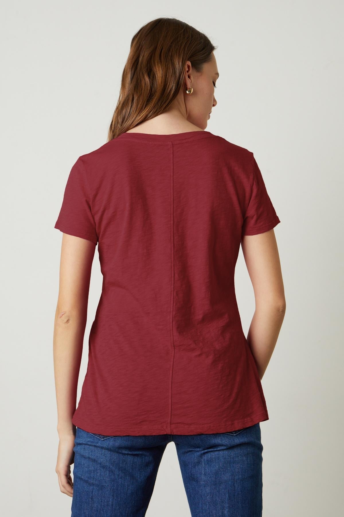 The back view of a woman wearing a Velvet by Graham & Spencer LILITH COTTON SLUB V-NECK TEE.-35782982271169