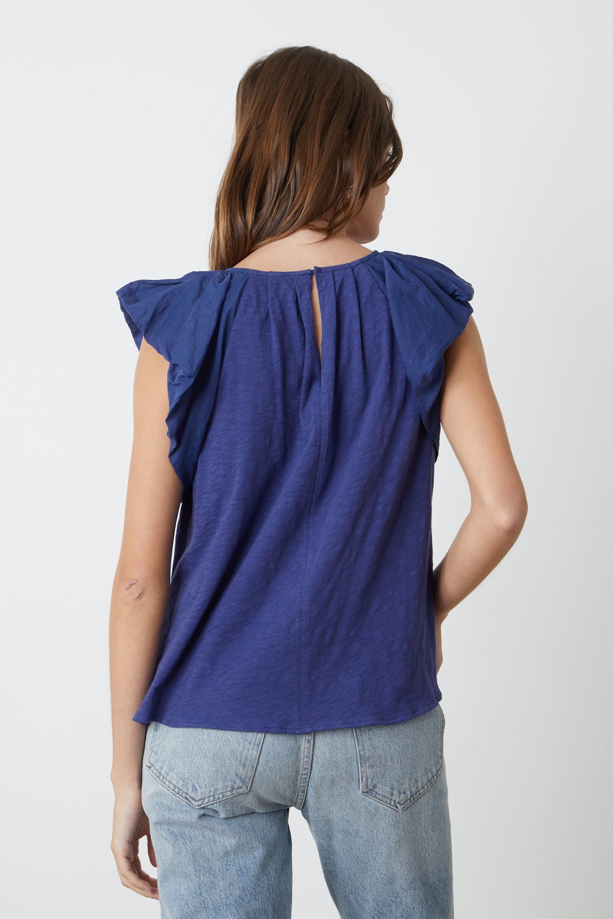 The back view of a woman wearing the Velvet by Graham & Spencer CARLY RUFFLE SLEEVE TOP.-35204852056257