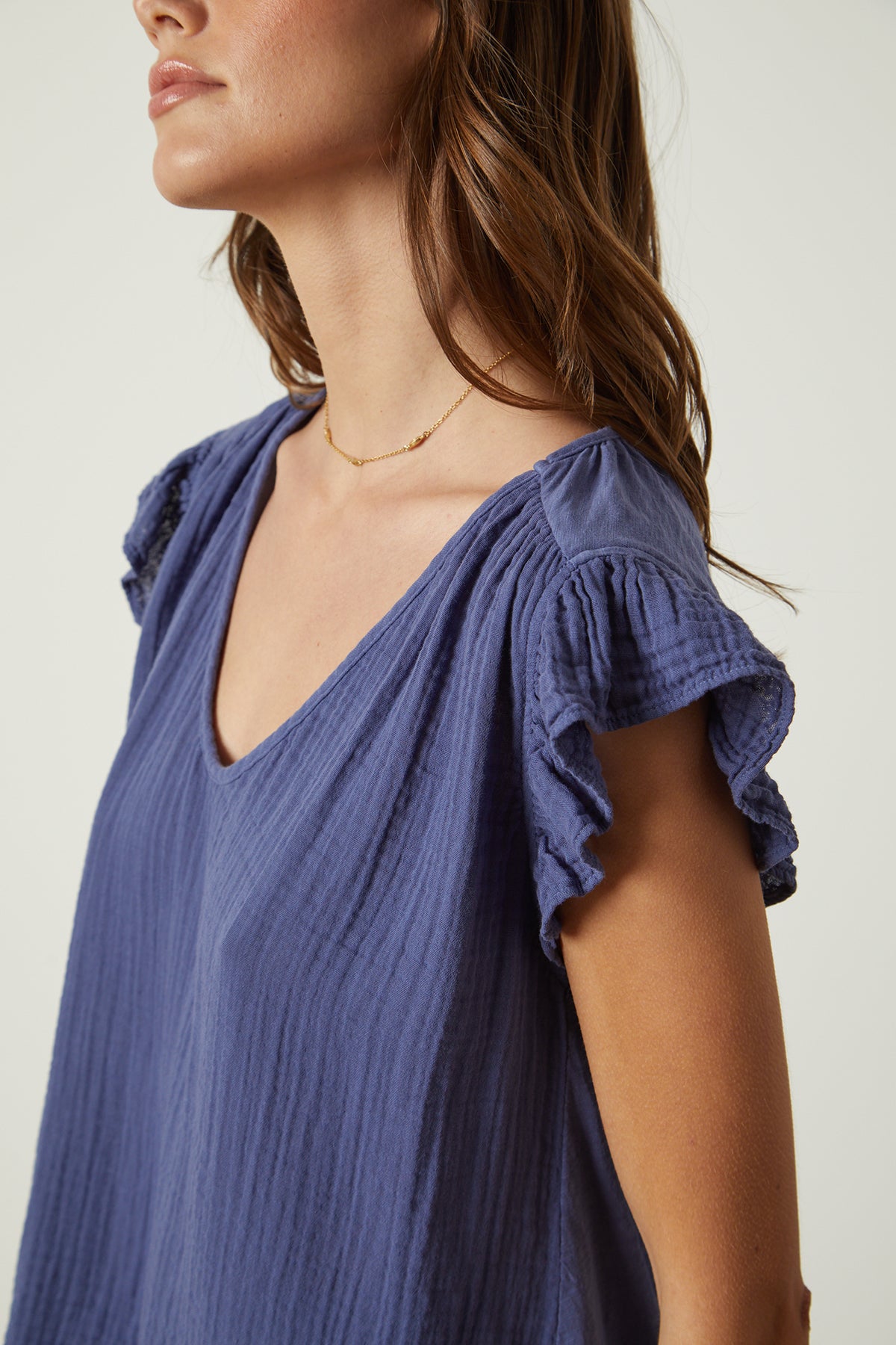   The model is wearing a Velvet by Graham & Spencer REMI RUFFLE SLEEVE TOP. 