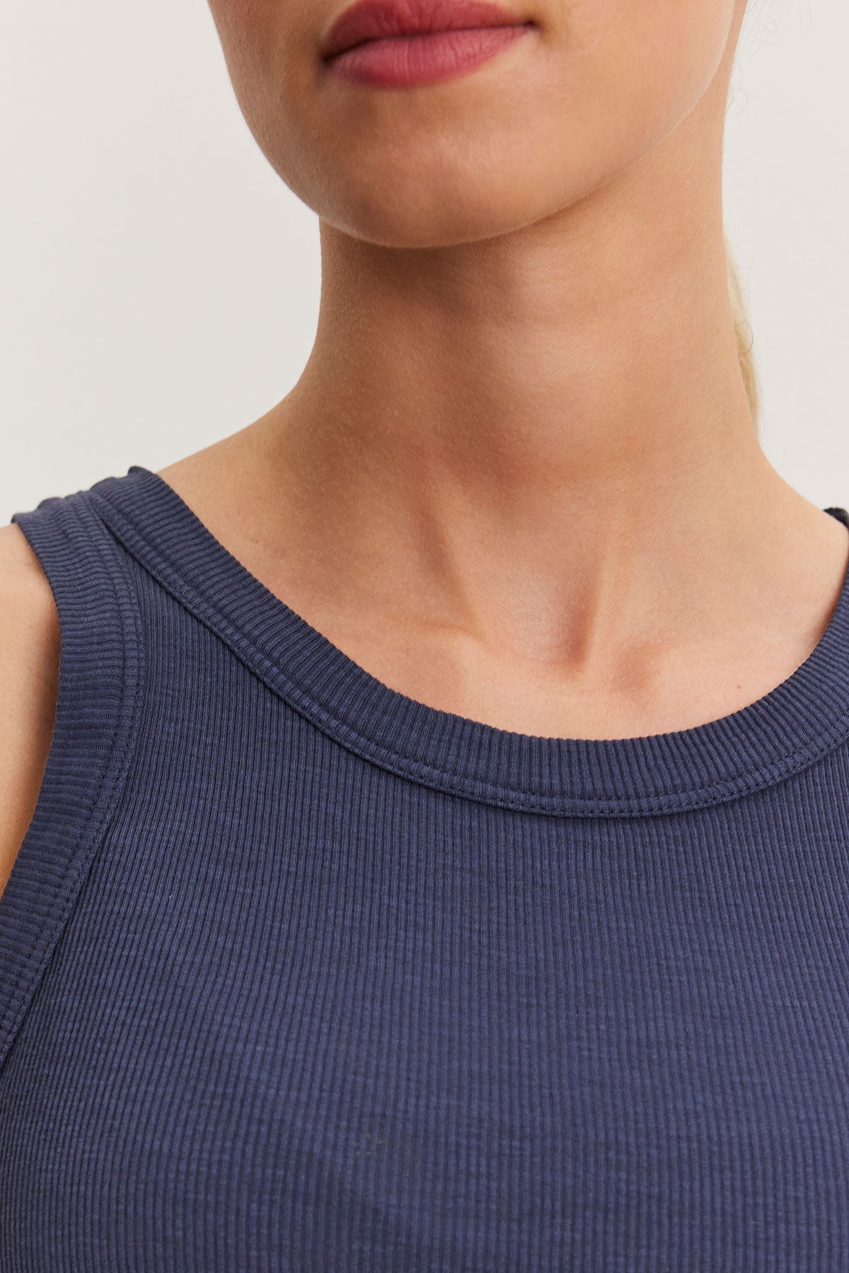   Close-up of a person wearing a Velvet by Graham & Spencer NOLA tank top, focusing on the neckline and collarbones. 