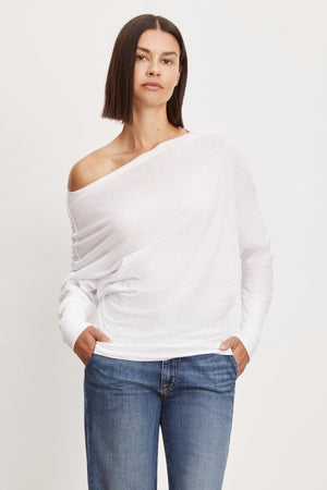 The model is wearing a white off-shoulder Velvet by Graham & Spencer NOVALEE DOLMAN TEE.