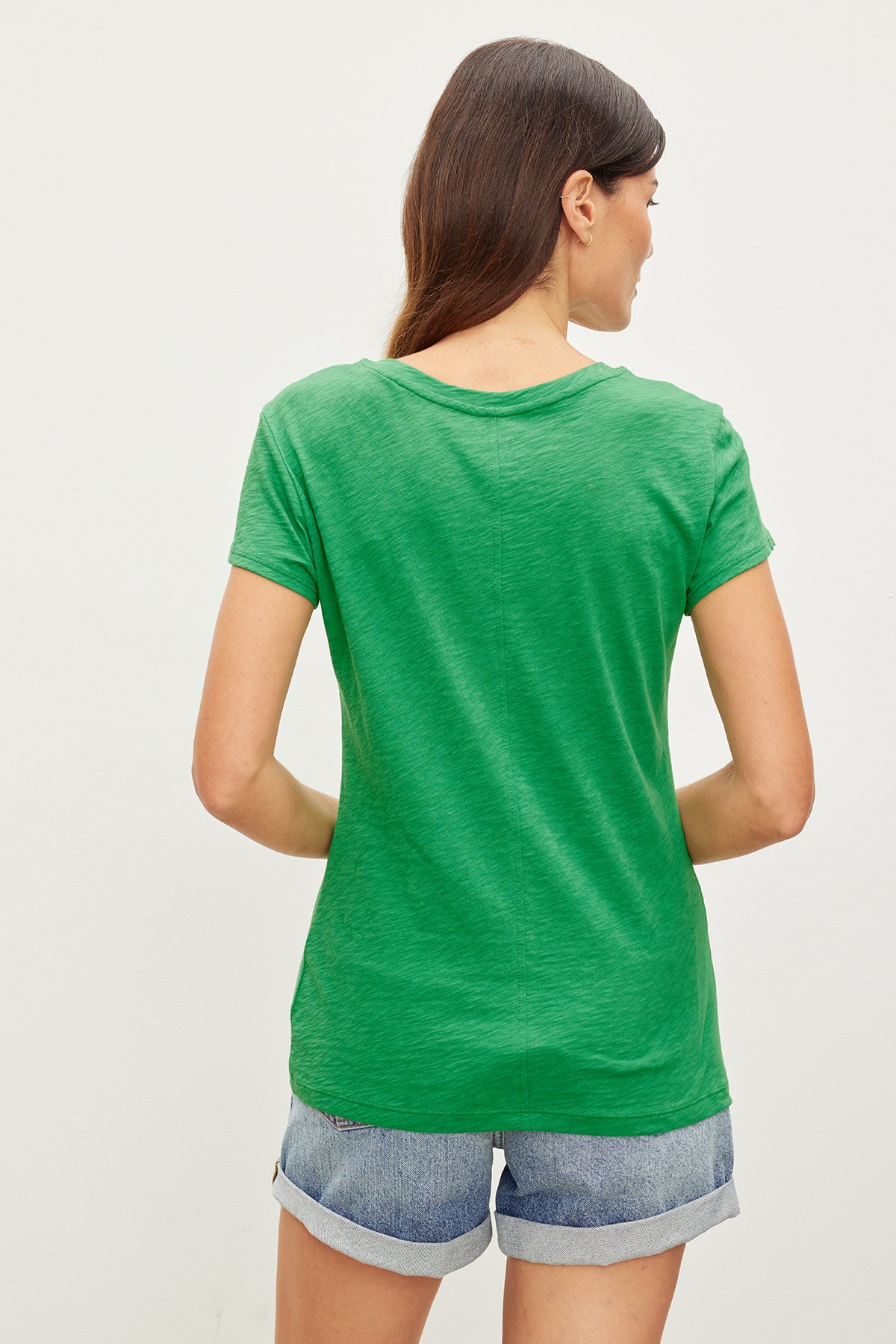 The back view of a woman wearing a Velvet by Graham & Spencer ODELIA COTTON SLUB CREW NECK TEE.-35982937850049