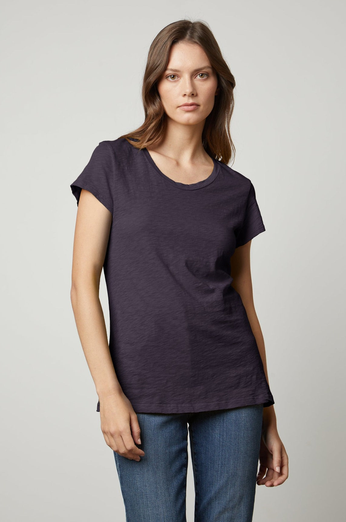 A woman wearing a ODELIA COTTON SLUB CREW NECK TEE by Velvet by Graham & Spencer and jeans.-26631431749825