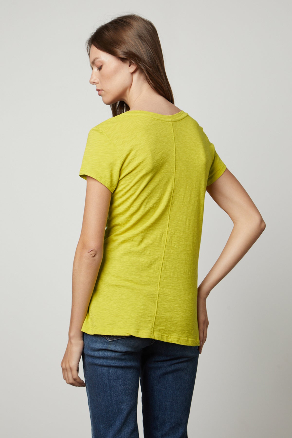   the back view of a woman wearing a Velvet by Graham & Spencer ODELIA COTTON SLUB CREW NECK TEE. 