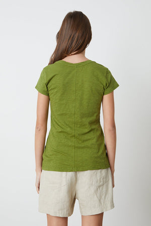 the back view of a woman wearing a Velvet by Graham & Spencer ODELIA COTTON SLUB CREW NECK TEE and beige shorts.
