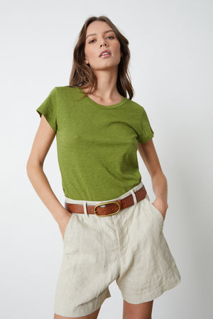The model is wearing a Velvet by Graham & Spencer Fallon Heavy Linen Short and beige shorts.