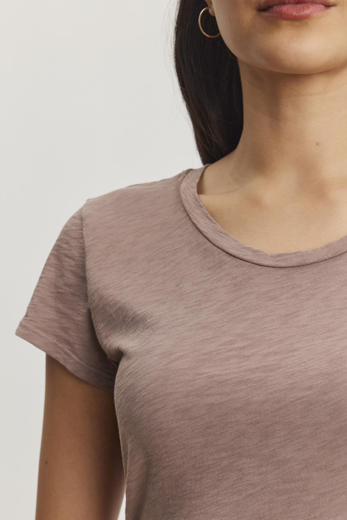   The ODELIA TEE by Velvet by Graham & Spencer features a classic crew neckline and short sleeves in light brown cotton slub, showcased on a plain white background—an essential piece for any wardrobe. 