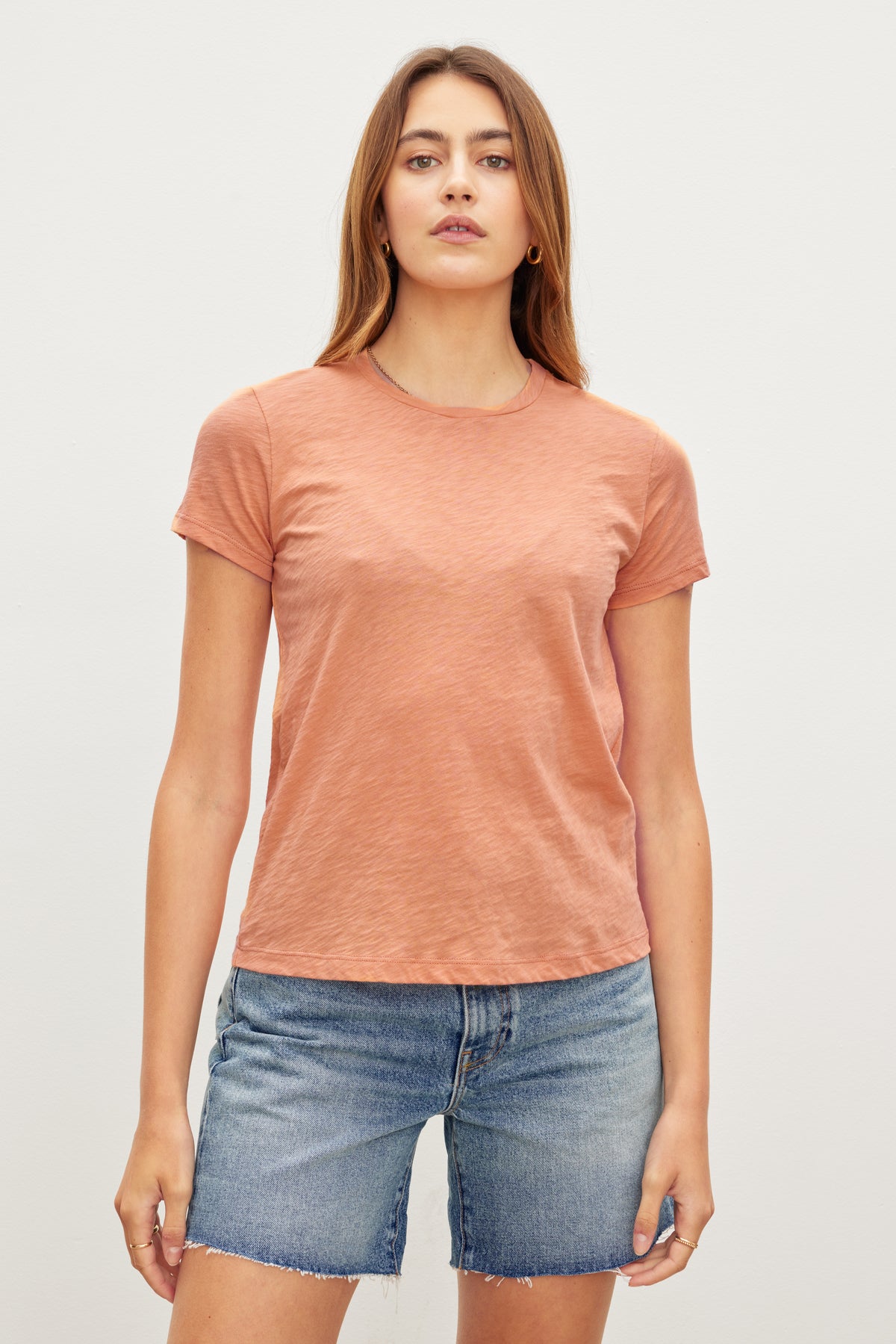 A woman in a retro vibe pink SIERRA CREW NECK TEE made from cotton slub, by Velvet by Graham & Spencer.-35982934868161