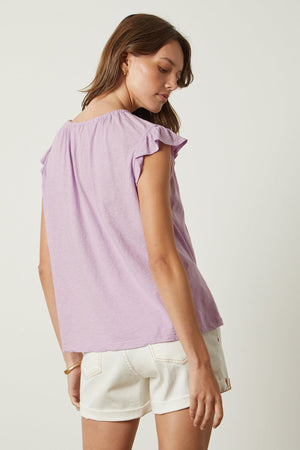 Stacy tank in lavender thistle tucked into white denim shorts back
