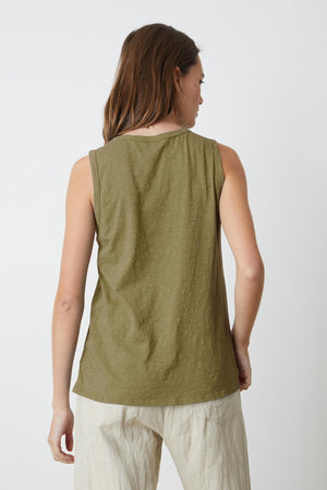 A woman in a Velvet by Graham & Spencer TAURUS COTTON SLUB TANK is shown from the back.