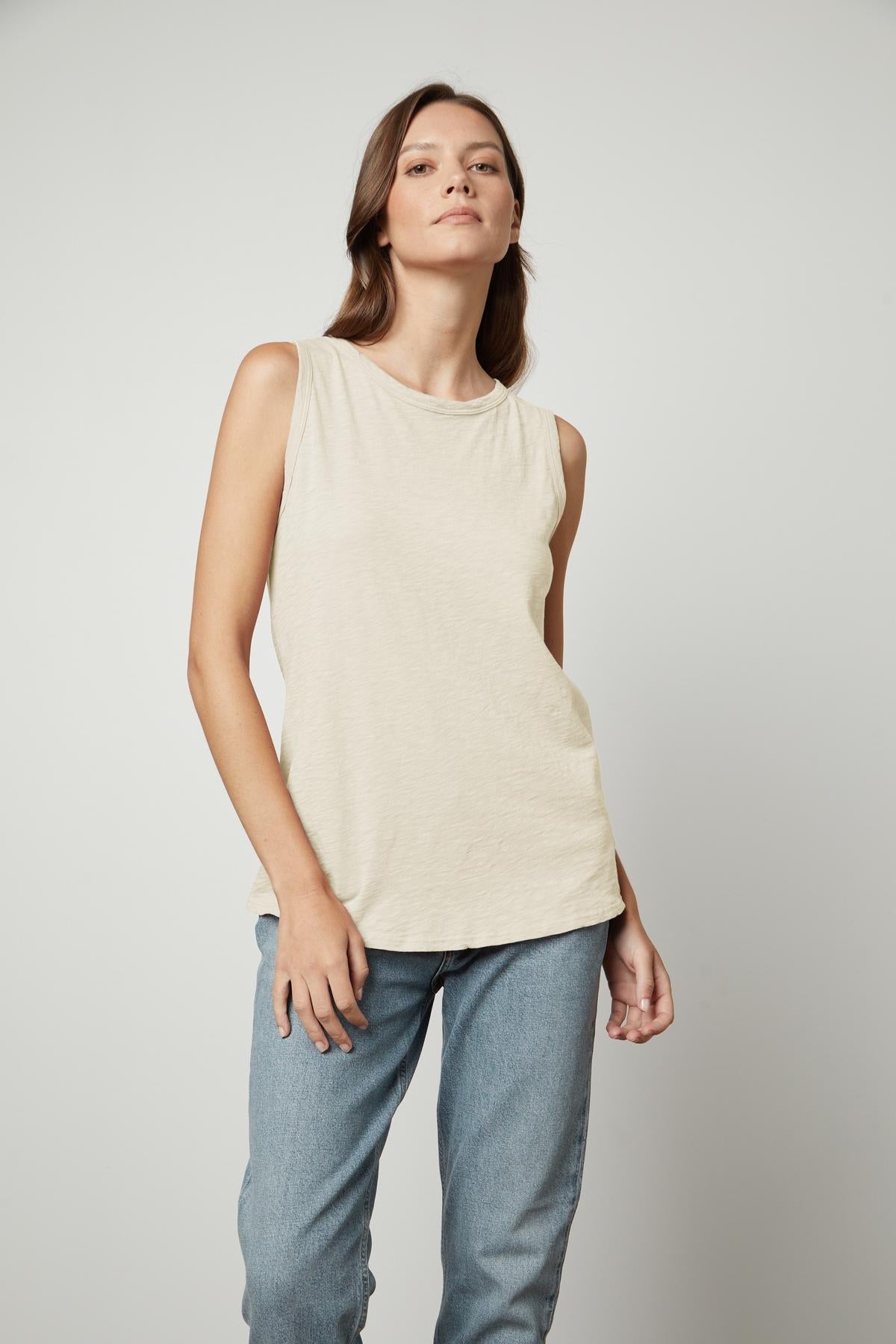   The model is wearing a TAURUS COTTON SLUB TANK by Velvet by Graham & Spencer and jeans. 