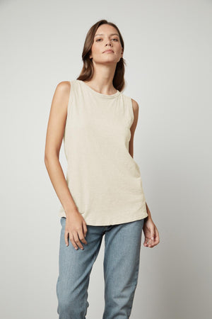 The model is wearing a TAURUS COTTON SLUB TANK by Velvet by Graham & Spencer and jeans.