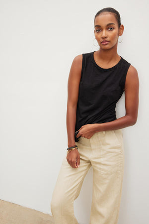 A woman wearing a TAURUS COTTON SLUB TANK by Velvet by Graham & Spencer and beige wide leg pants.