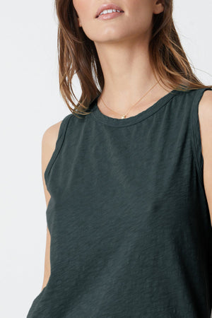 The model is wearing a Velvet by Graham & Spencer TAURUS COTTON SLUB TANK.