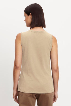 A woman wearing a Velvet by Graham & Spencer Taurus Cotton Slub Tank with a crew-neck design.