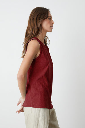 A woman wearing a red crew-neck top and Velvet by Graham & Spencer TAURUS COTTON SLUB TANK.