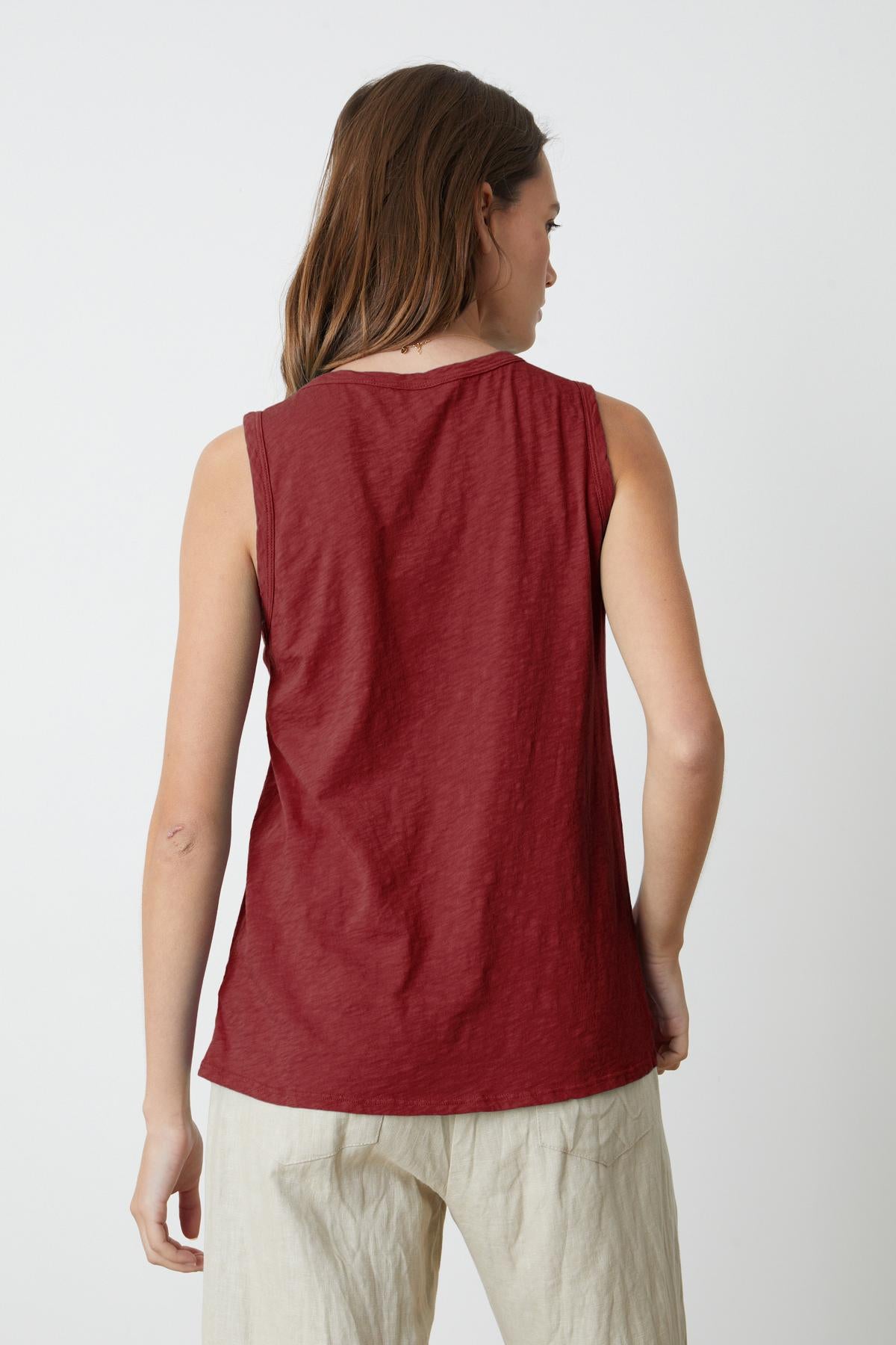   The tomboy-inspired woman is seen from the back in a Velvet by Graham & Spencer TAURUS COTTON SLUB TANK. 