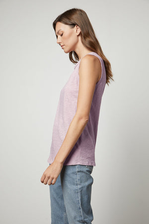 A woman wearing a Velvet by Graham & Spencer TAURUS COTTON SLUB TANK and jeans.
