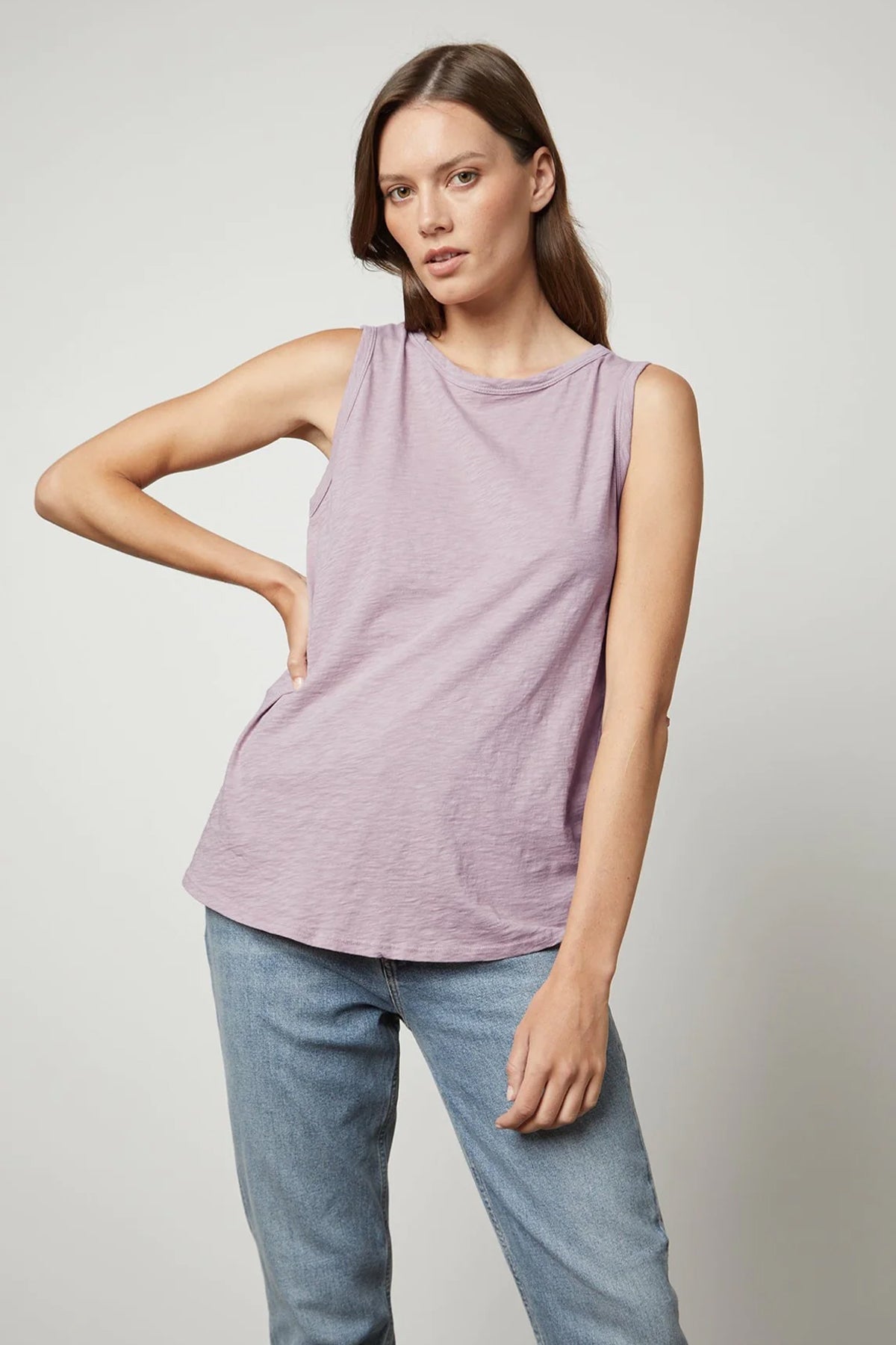 a model wearing a Velvet by Graham & Spencer TAURUS COTTON SLUB TANK and jeans.-26632368914625