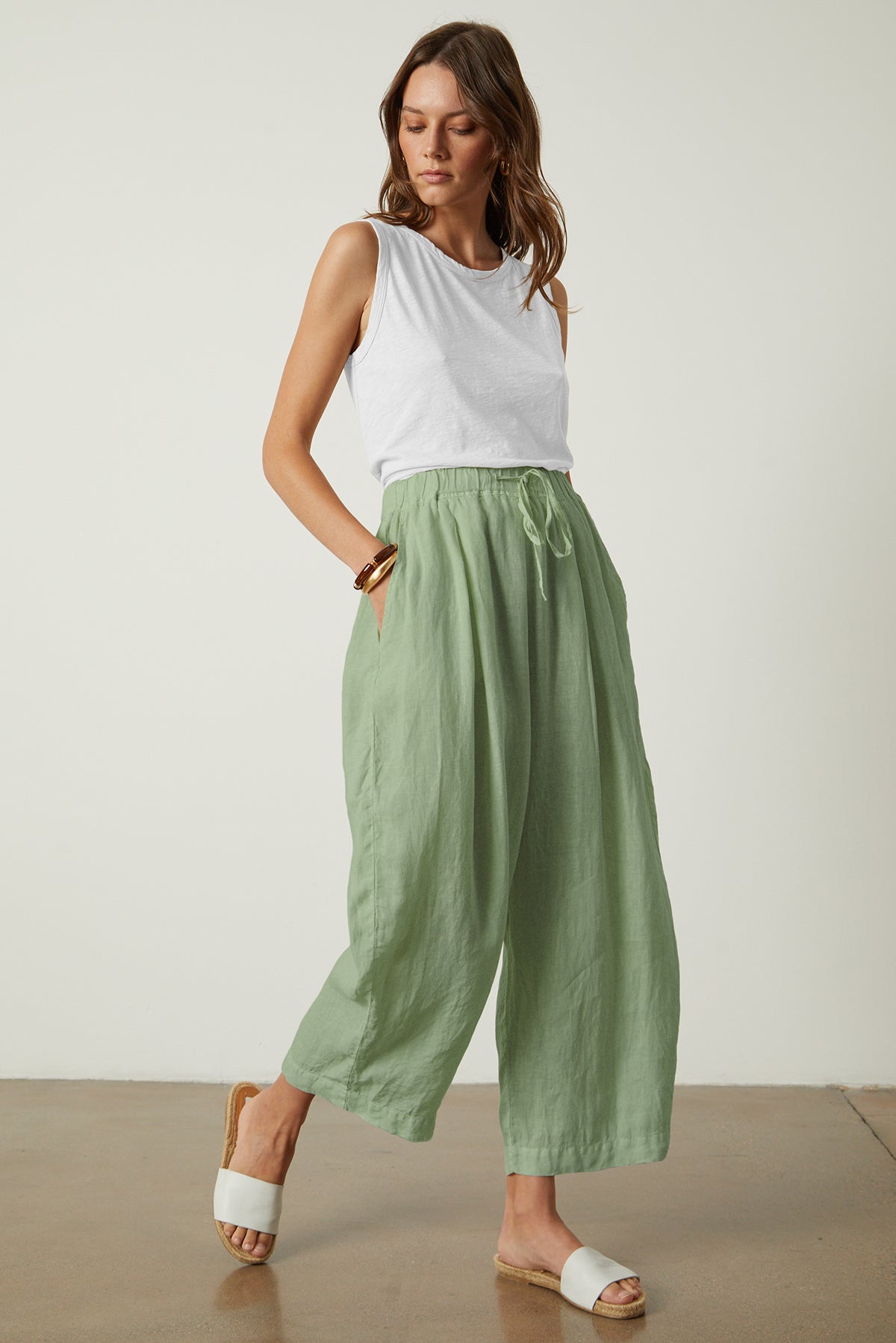A woman wearing the Velvet by Graham & Spencer Hannah Linen Wide Leg Pant with a cropped leg.-35982213415105