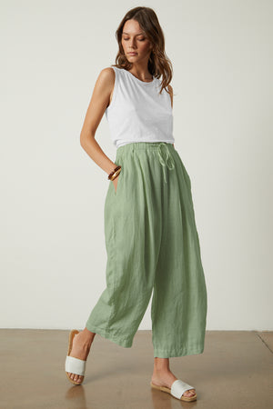 A woman wearing the Velvet by Graham & Spencer Hannah Linen Wide Leg Pant with a cropped leg.