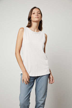 a woman wearing a Velvet by Graham & Spencer TAURUS COTTON SLUB TANK and jeans.