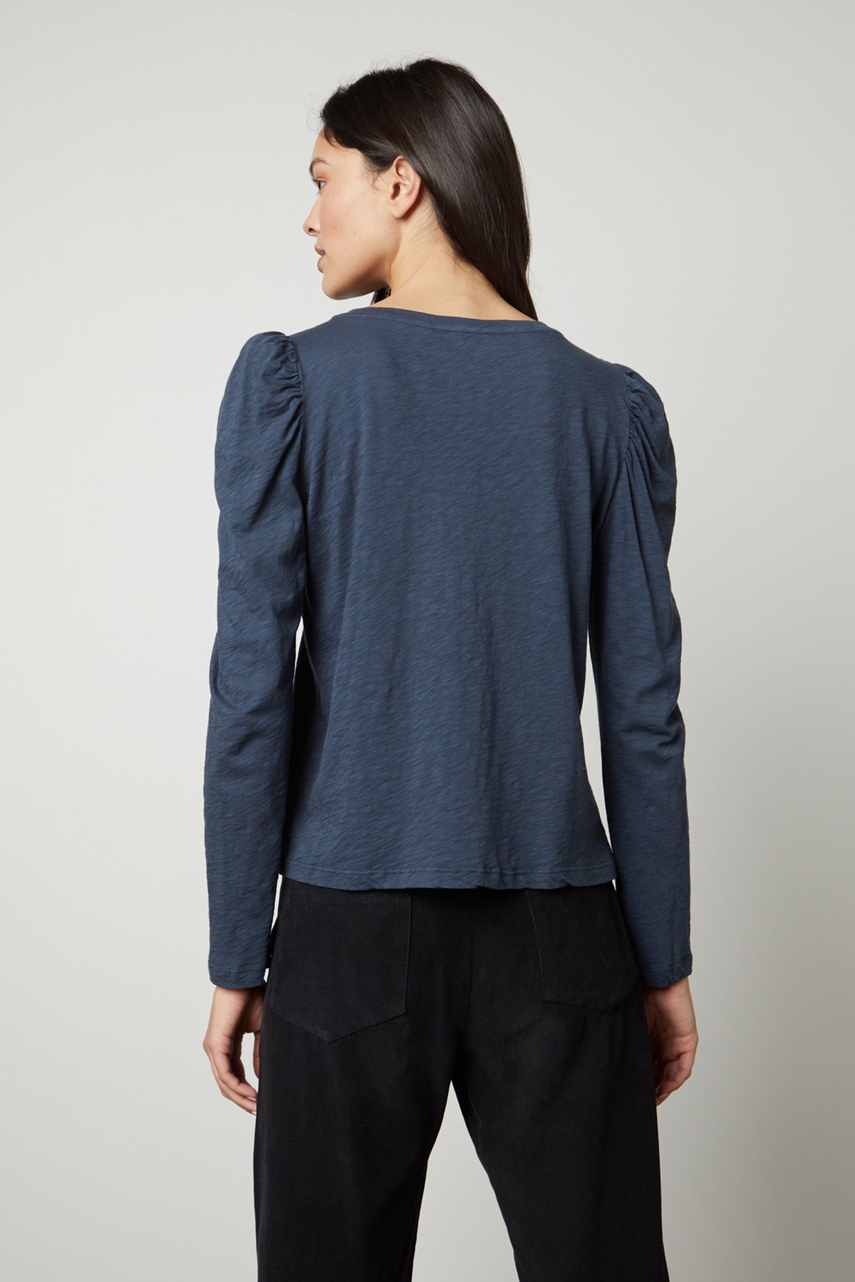   The back view of a woman wearing a Velvet by Graham & Spencer TORA CREW NECK TEE. 