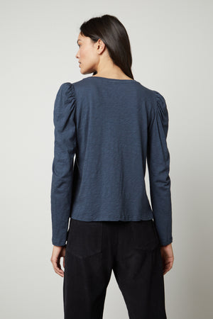 The back view of a woman wearing a Velvet by Graham & Spencer TORA CREW NECK TEE.