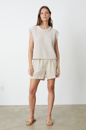 The model is wearing a Velvet by Graham & Spencer SAGE CREW NECK SWEATER and shorts.