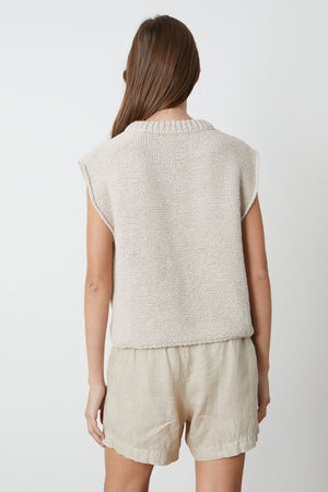 the back view of a woman wearing a Velvet by Graham & Spencer SAGE CREW NECK SWEATER and shorts.